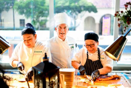 Three chefs prep food at a restaurant in San Jose