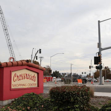 Capitol Exp 4 A shopping center sign in the foreground, with a construction crane in the background