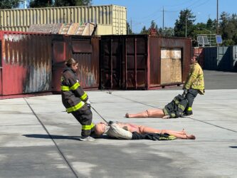 SJFD-Boot Camp -2 Two women in firefighter gear during a training exercise in San Jose, California