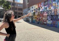 A woman stands pointing to a mural in San Jose, California