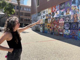 Local Color Erin Salazar A woman stands pointing to a mural in San Jose, California