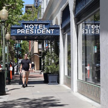 A person walking under the awning of a hotel in Palo Alto, California