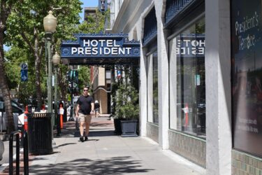 Một người đang đi bộ dưới mái hiên của một khách sạn ở Palo Alto, California.