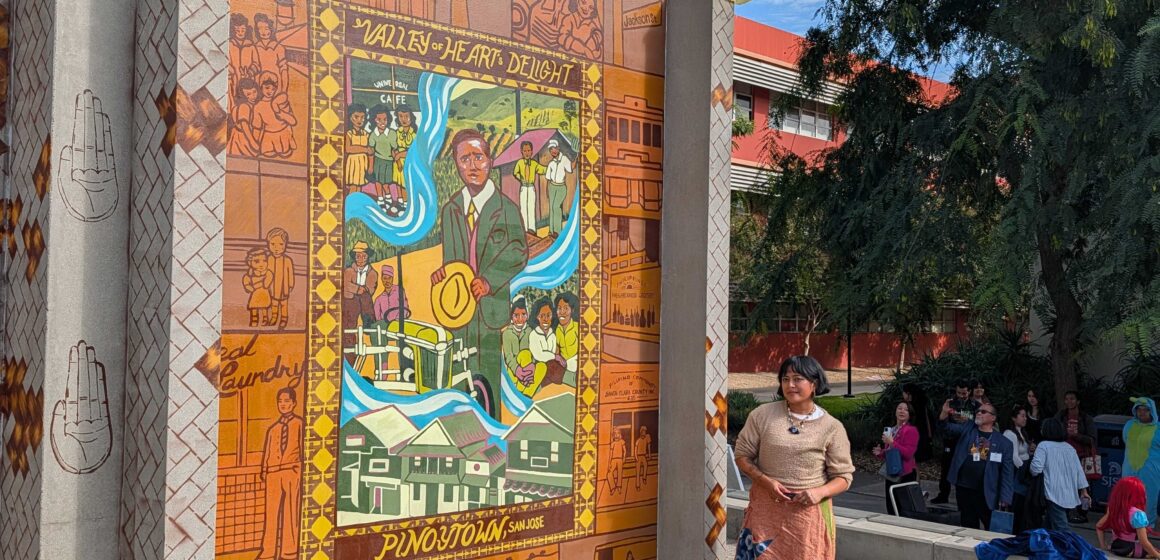SJSU Filipino Mural A woman standing next to a mural on a college campus in San Jose, California